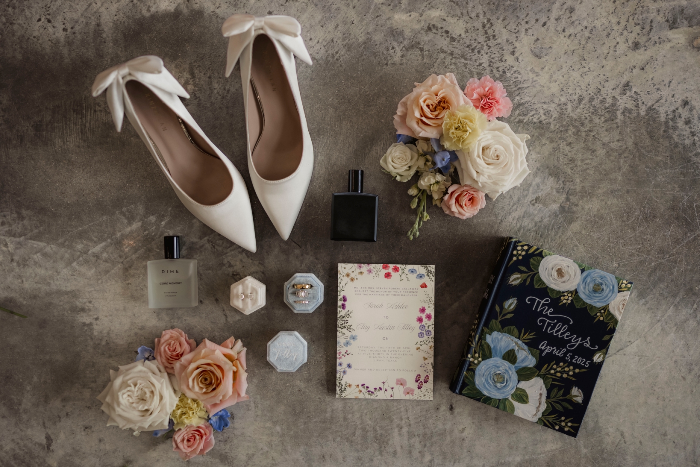 A flat-lay of floral wedding invitations with white heels