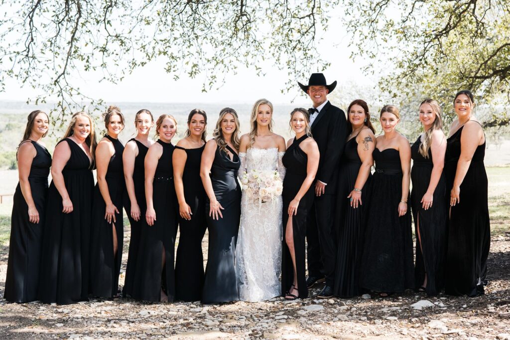 Bride and groom lined up with bridesmaids at Diamond A Ranch in Granbury, TX.