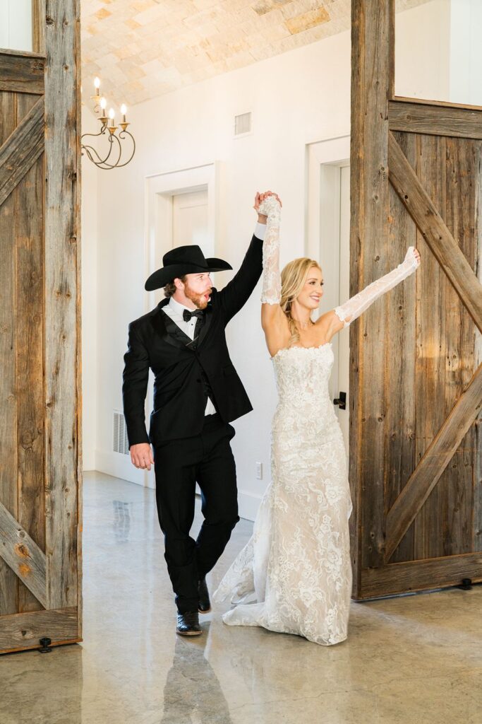 Bride and groom entering their wedding reception at Diamond A Ranch.