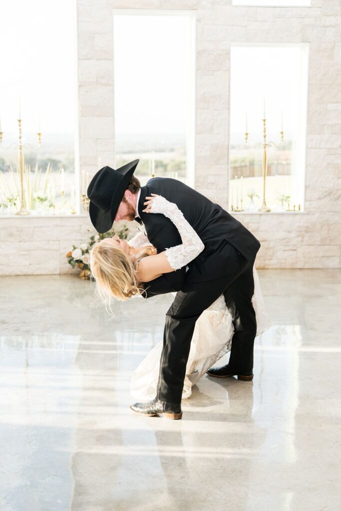 Groom dipping his bride while dancing at Diamond A Ranch wedding.