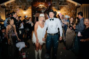 A bride and groom being showered with bubbles during their grand exit