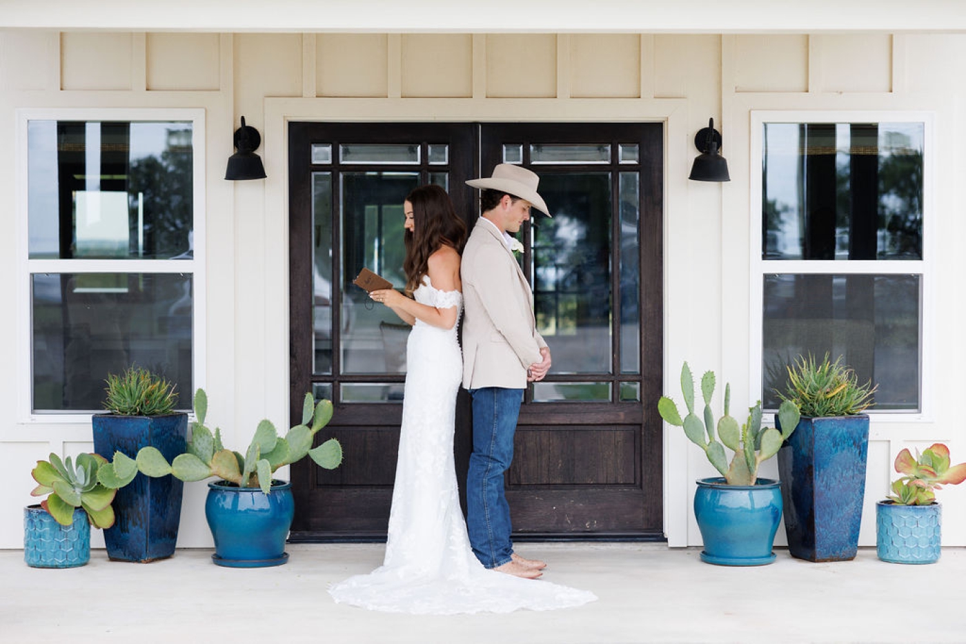 A bride and groom exchange private vows on the porch of an outdoor wedding venue in Texas