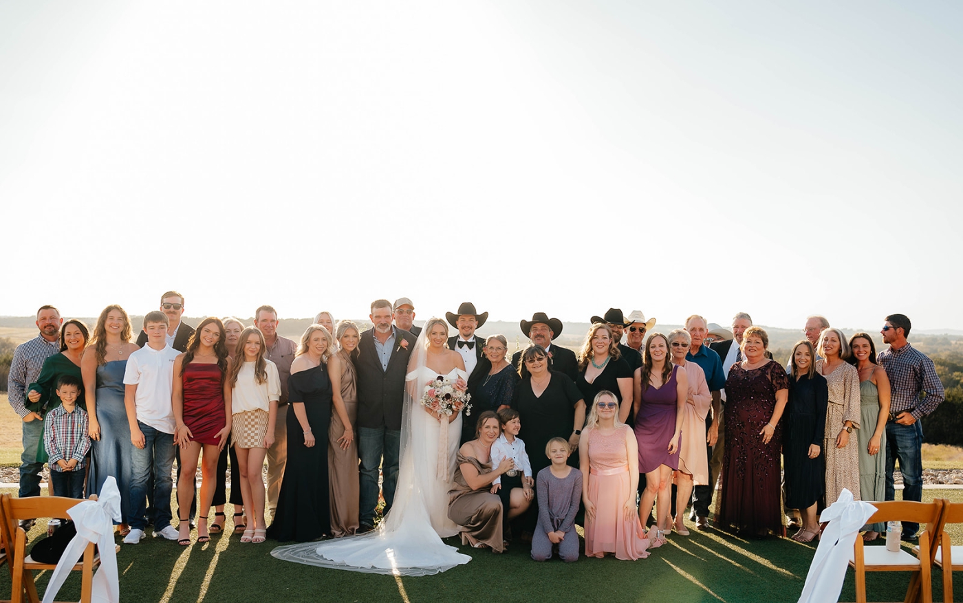 A bride and groom standing with their wedding guests after the wedding ceremony at the Diamond A Ranch