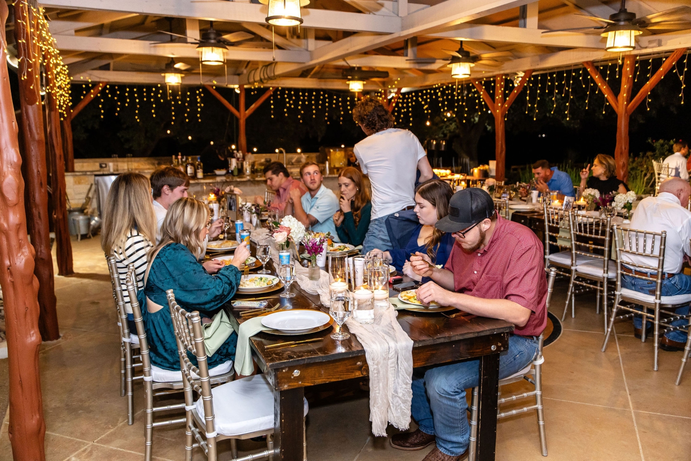 A wedding party enjoying a rehearsal dinner in Fort Worth, Texas at the Diamond A Ranch