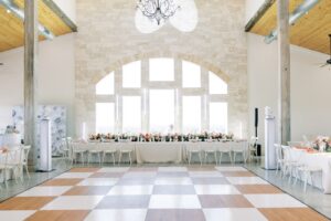 A pink and white dance floor at the Diamond A Ranch, a Weatherford wedding venu