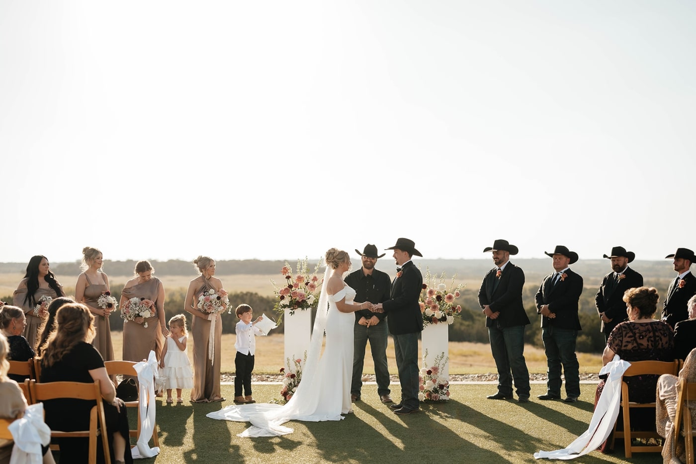 A bride and groom stand at the altar holding hands during their wedding ceremony