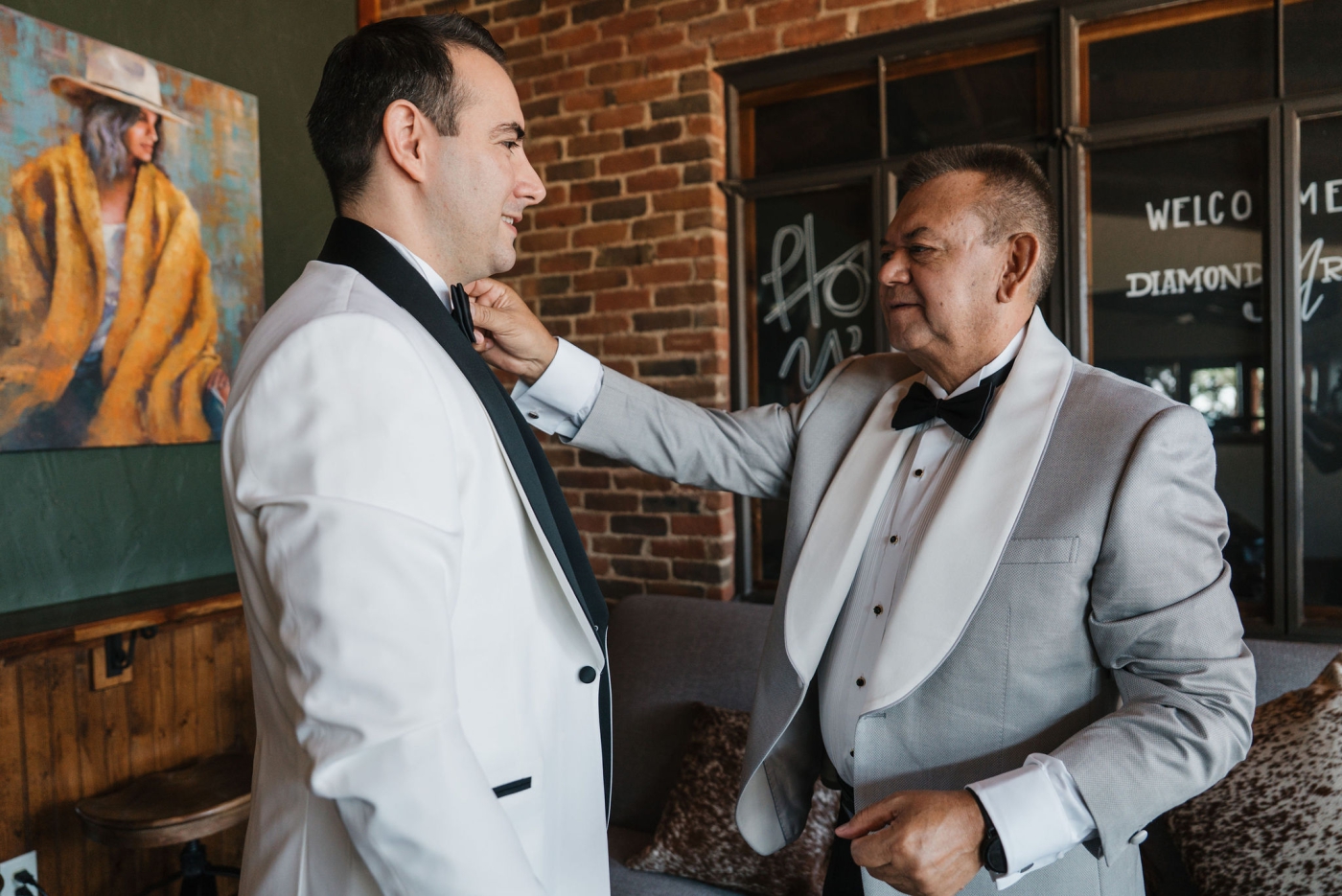 The father of the groom greets the groom before the wedding ceremony