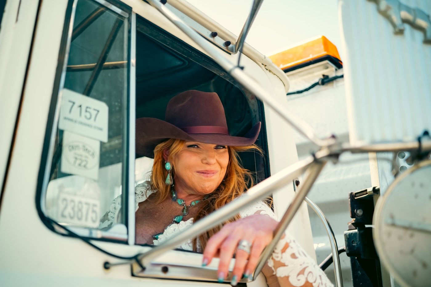 Bride wearing a brown cowboy hat and turquoise earrings