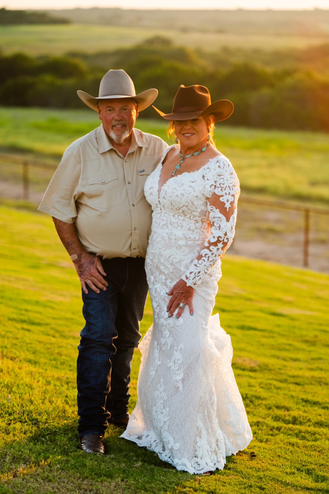 Bride and groom wearing cowboy hats