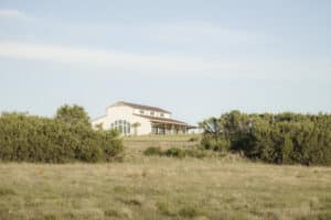 White ranch house on a hill
